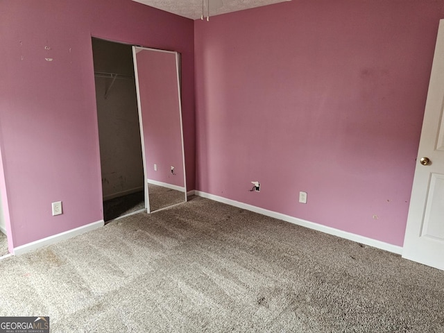 unfurnished bedroom featuring carpet flooring and a closet