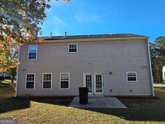 rear view of house with a yard and a patio