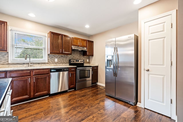 kitchen with backsplash, stainless steel appliances, dark hardwood / wood-style floors, and sink