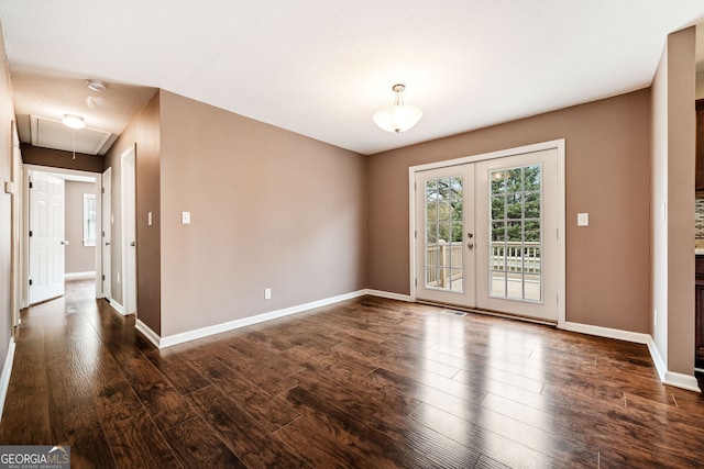 spare room with french doors and dark wood-type flooring