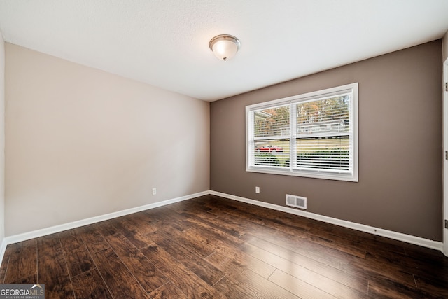 empty room featuring dark hardwood / wood-style floors