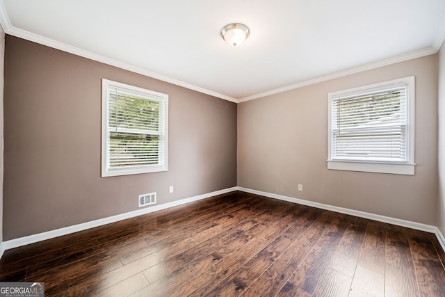 spare room with dark wood-type flooring and ornamental molding