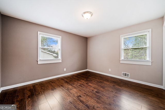 empty room featuring dark wood-type flooring