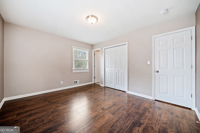 unfurnished bedroom featuring dark wood-type flooring