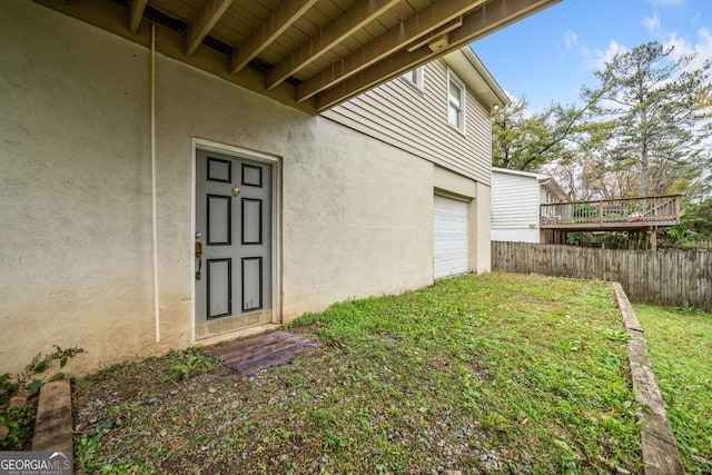 view of yard featuring a wooden deck and a garage