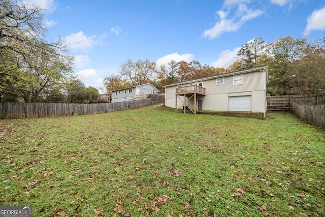 view of yard featuring a garage and a wooden deck