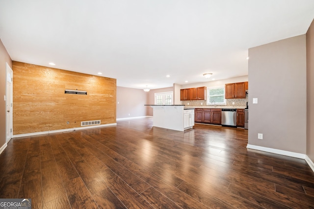 unfurnished living room featuring dark hardwood / wood-style floors and wood walls