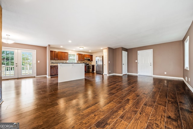 unfurnished living room featuring french doors and dark wood-type flooring