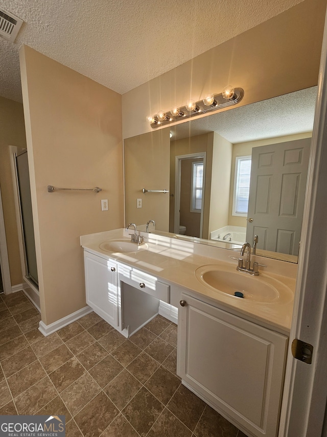 full bathroom featuring vanity, shower with separate bathtub, a textured ceiling, and toilet