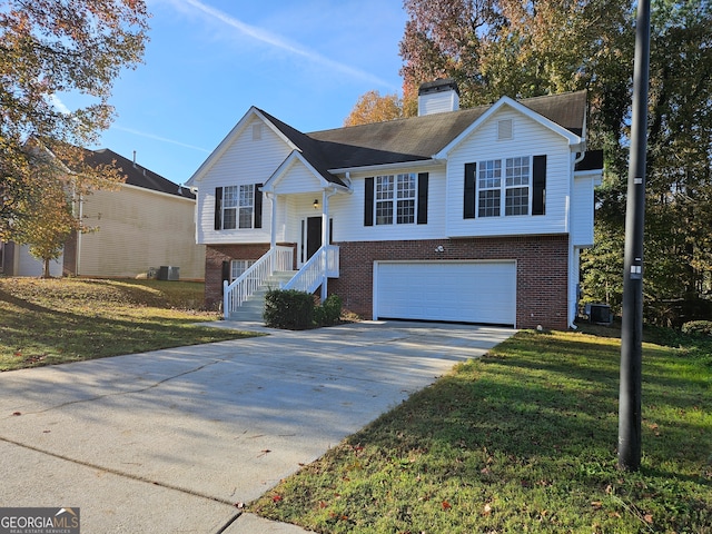 split foyer home featuring a garage and a front lawn