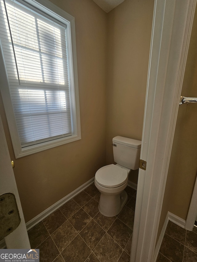 bathroom with tile patterned flooring and toilet