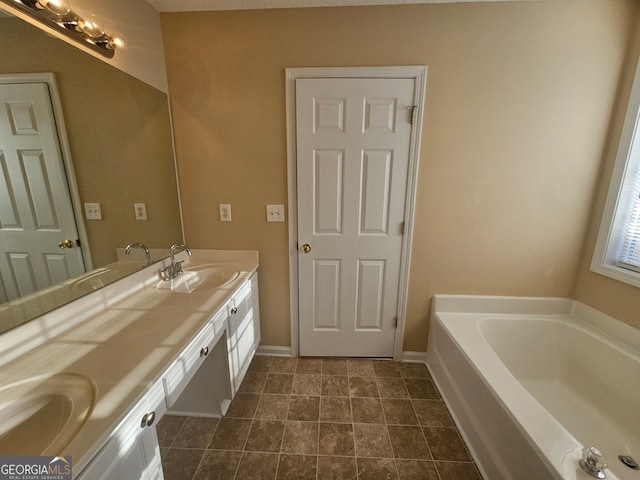 bathroom with a tub and vanity