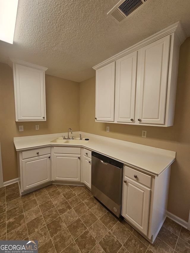 kitchen with dishwasher, a textured ceiling, white cabinets, and sink