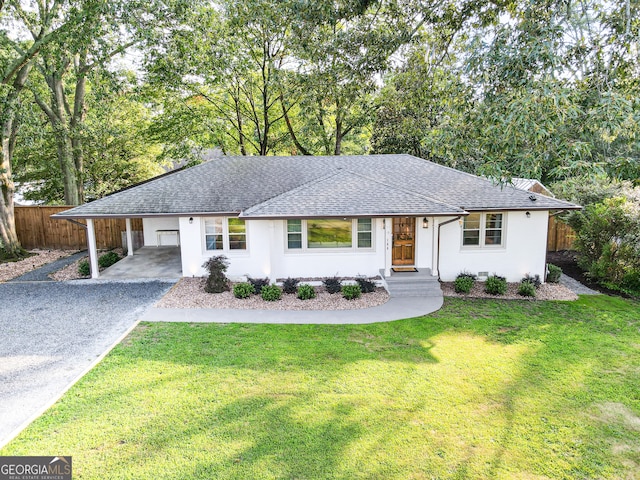 ranch-style home featuring a front yard and a carport