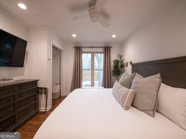 bedroom featuring ceiling fan, ornamental molding, and dark wood-type flooring