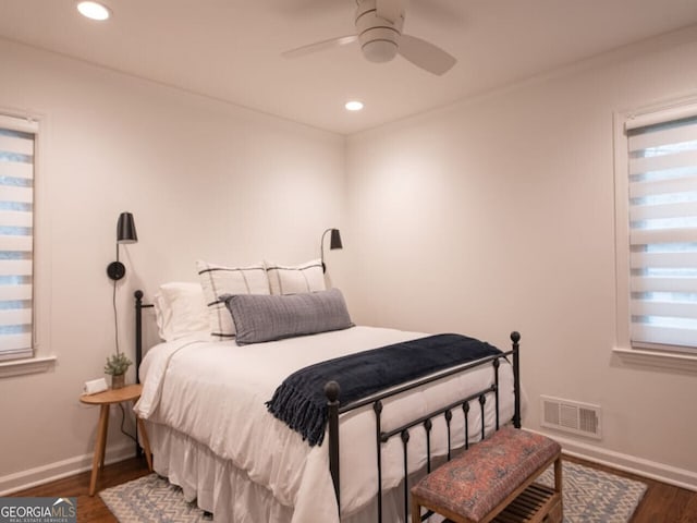 bedroom with ceiling fan, dark hardwood / wood-style flooring, and ornamental molding