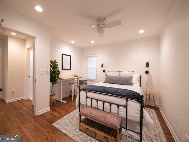 bedroom featuring dark hardwood / wood-style floors, ceiling fan, and crown molding