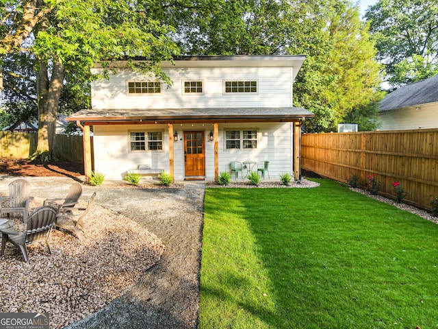 view of front facade with a front yard and a patio