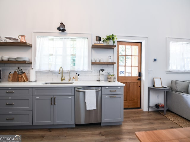 kitchen with gray cabinetry, dishwasher, dark hardwood / wood-style floors, and sink