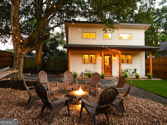 back of house with a fire pit