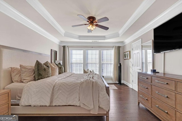 bedroom featuring a raised ceiling, ceiling fan, dark hardwood / wood-style flooring, and crown molding