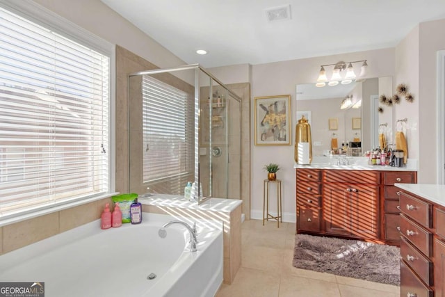 bathroom featuring tile patterned flooring, shower with separate bathtub, vanity, and a wealth of natural light