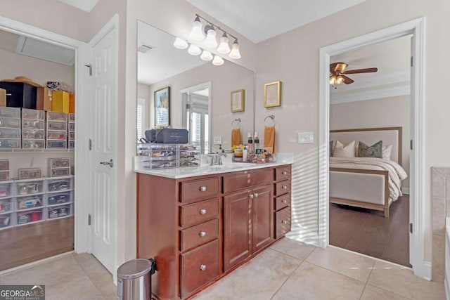 bathroom featuring wood-type flooring, vanity, ceiling fan, and ornamental molding