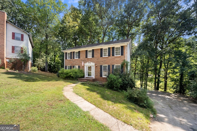 colonial home with a front lawn