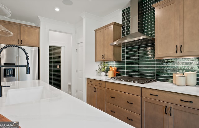 kitchen with decorative backsplash, appliances with stainless steel finishes, ornamental molding, and wall chimney exhaust hood