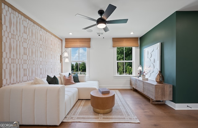 living room with a wealth of natural light, ceiling fan, and hardwood / wood-style flooring