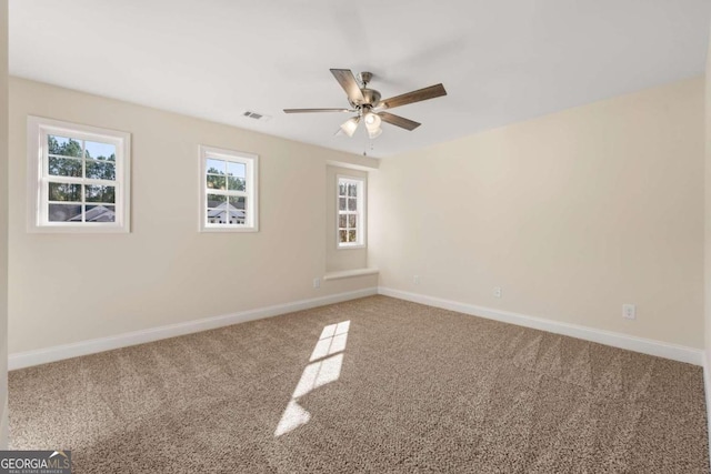 carpeted empty room featuring ceiling fan