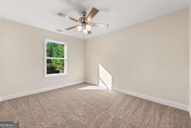 spare room with light carpet and ceiling fan