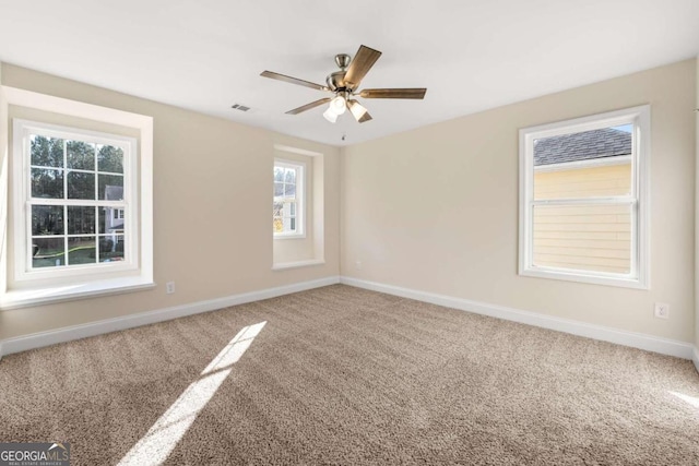 unfurnished room with carpet flooring and ceiling fan