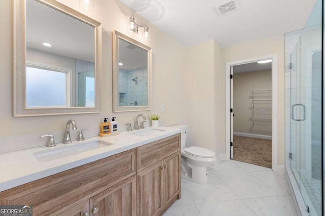 bathroom featuring vanity, toilet, and an enclosed shower