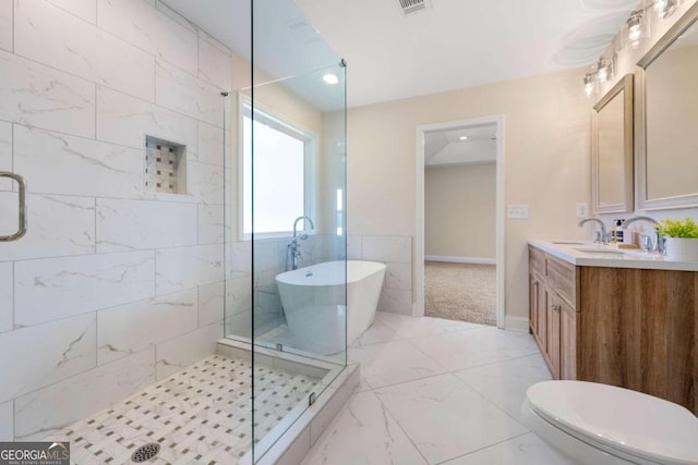 full bathroom featuring vanity, toilet, and shower with separate bathtub