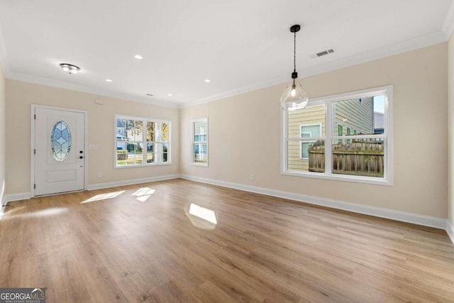 foyer entrance featuring light wood-type flooring and crown molding