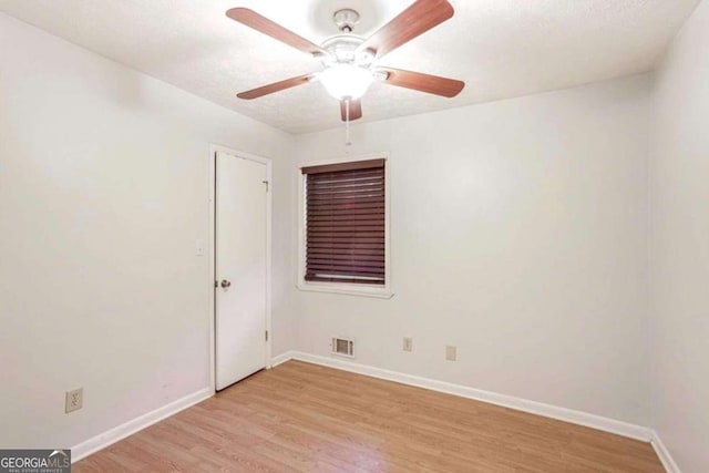 empty room with ceiling fan and light wood-type flooring