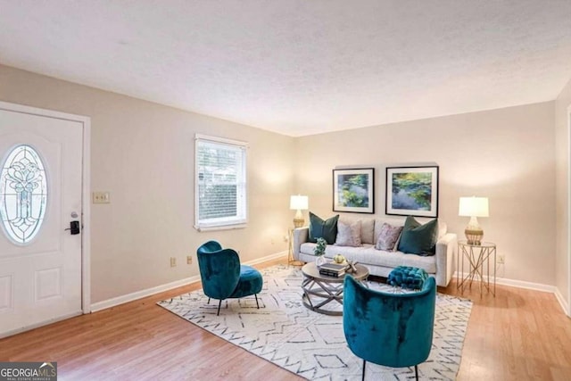 living room featuring a textured ceiling and light hardwood / wood-style floors