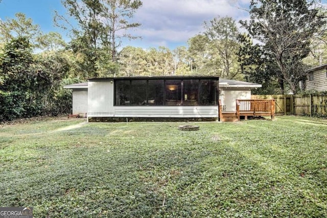 back of house with a yard and a wooden deck