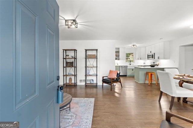 interior space with sink and hardwood / wood-style flooring