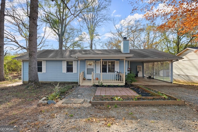 view of front facade with covered porch and a carport