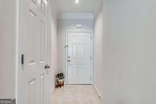 doorway featuring ornamental molding and light tile patterned flooring