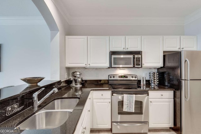 kitchen featuring white cabinetry, sink, dark stone countertops, and appliances with stainless steel finishes