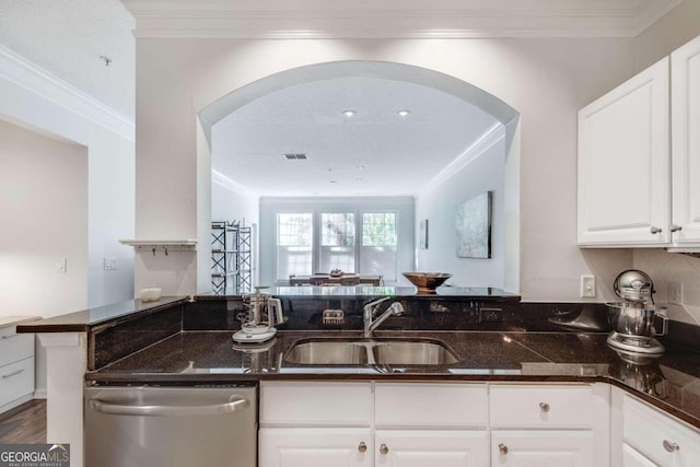 kitchen with sink, dishwasher, kitchen peninsula, dark stone counters, and white cabinets