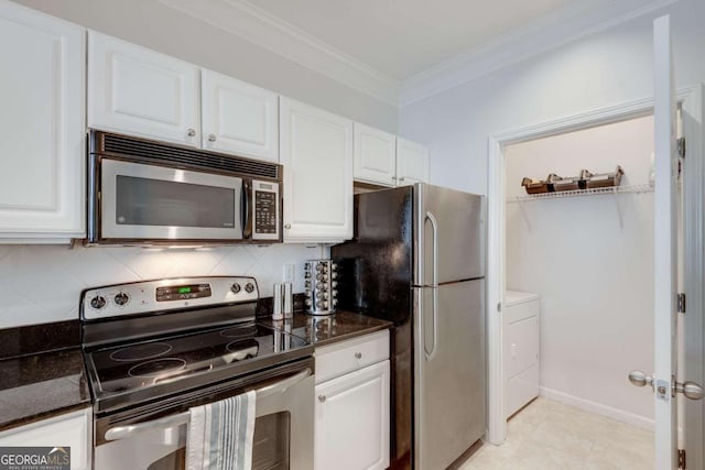 kitchen with white cabinetry, ornamental molding, washing machine and dryer, and appliances with stainless steel finishes