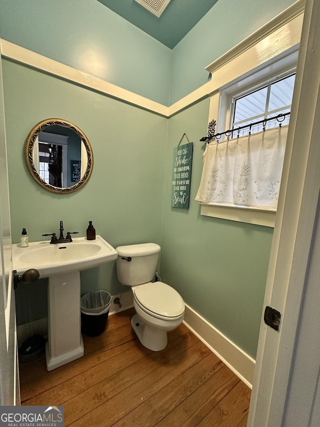 bathroom featuring hardwood / wood-style floors, toilet, and sink