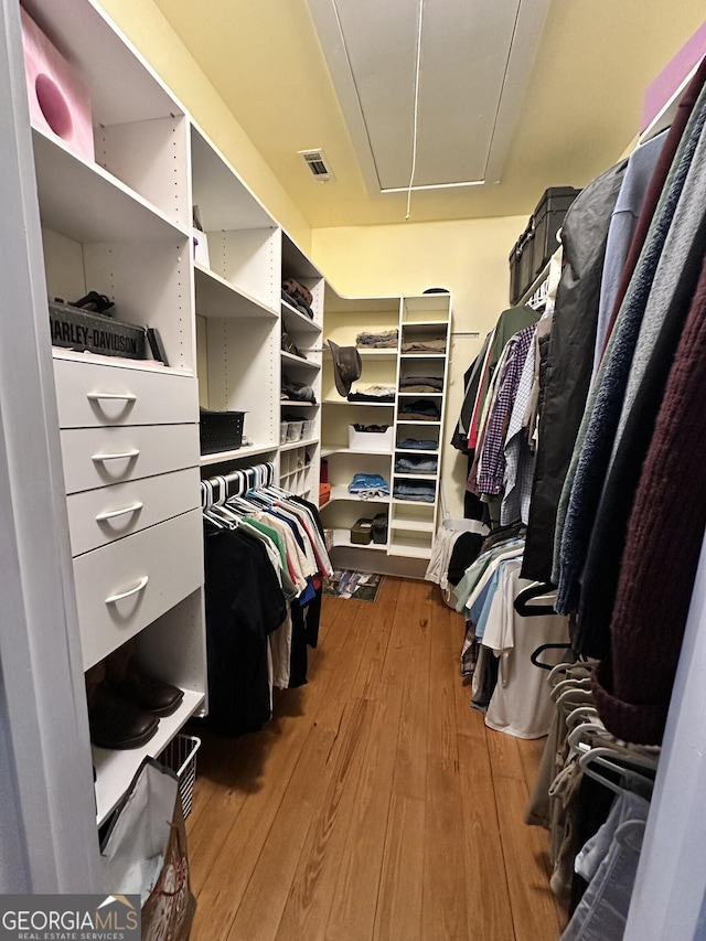 spacious closet featuring hardwood / wood-style flooring