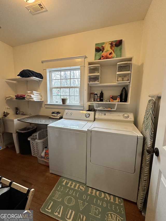 laundry area with washing machine and dryer and dark hardwood / wood-style floors