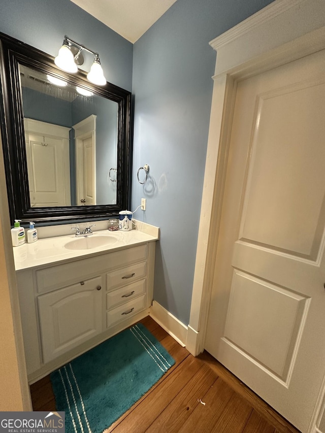 bathroom with vanity and hardwood / wood-style flooring