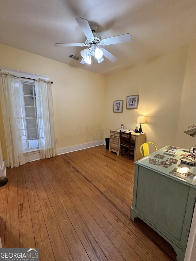 unfurnished bedroom featuring hardwood / wood-style floors and ceiling fan